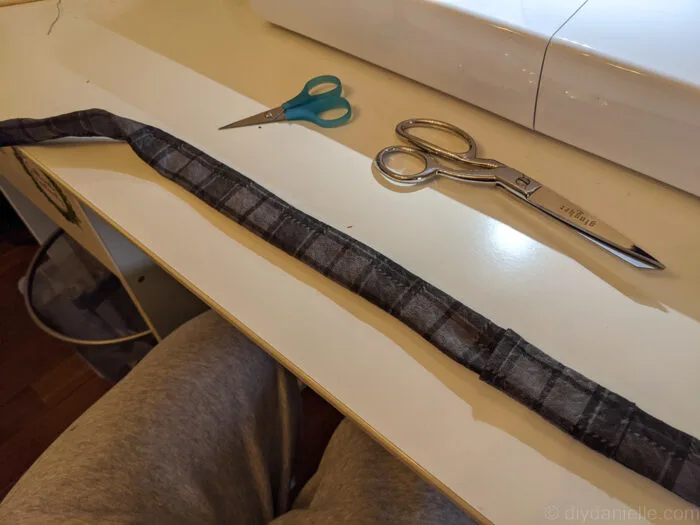 Fabric guitar strap turned right side out with visible topstitching along the edges.