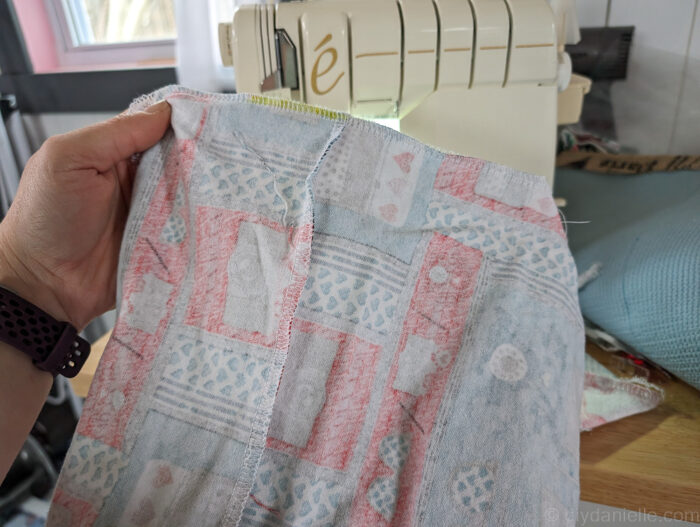 You can see here where the corners of the bag have been cut off and sewed. I used a serger instead of my sewing machine, but reinforced with my sewing machine as well to improve the durability of my bag and to prevent fraying.