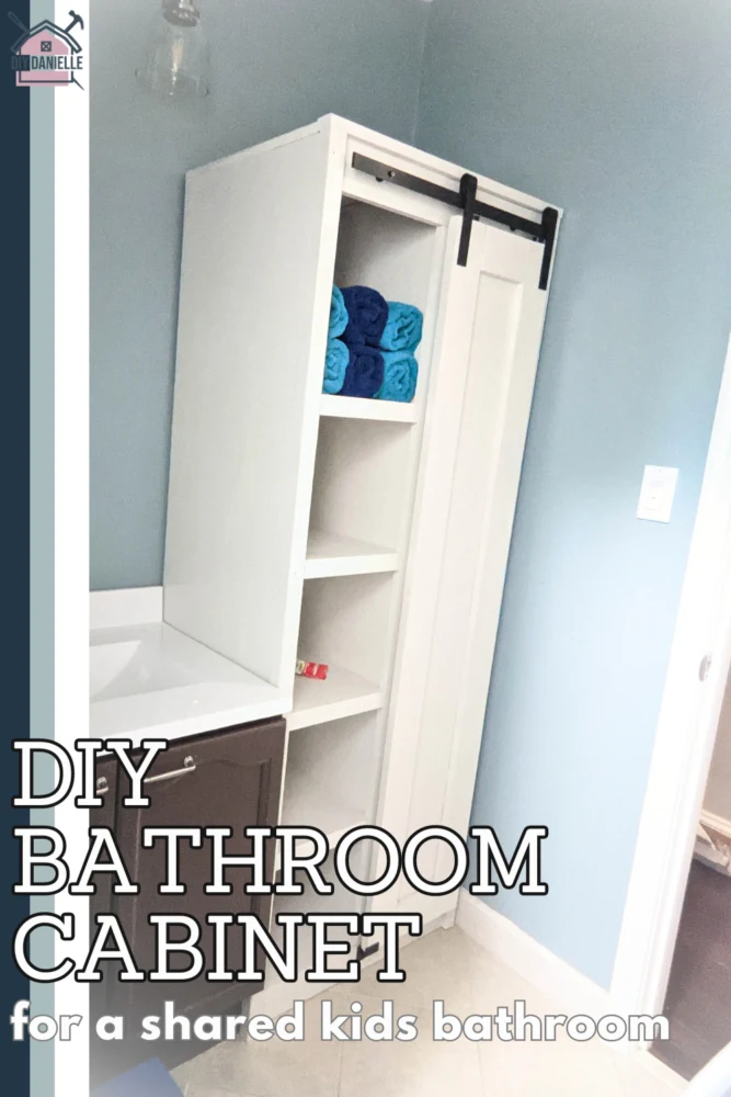 DIY Bathroom cabinet for a shared kids bathroom. The white cabinet has a sliding barn door and isn't floor to ceiling. This was a relatively affordable build. 