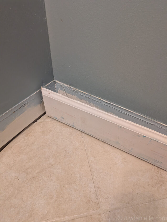 Removing the baseboards before installing the new cabinets.