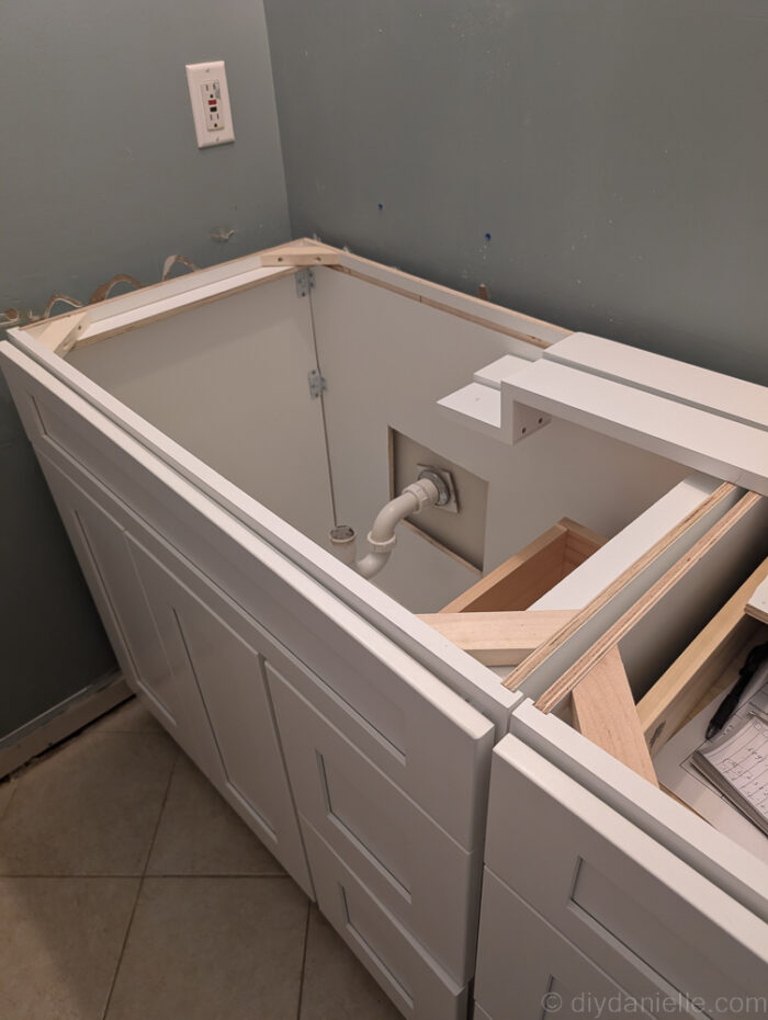 Cabinet back needed to be cut out to pull the plumbing through, and we also cut the bottom as well. This was tricky to fit inside. This is an above view of the shaker cabinet before we added the countertop.