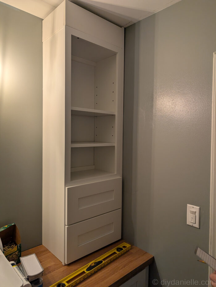 Prepping the cabinets to increase the height so we can add crown molding around the top of the cabinet.