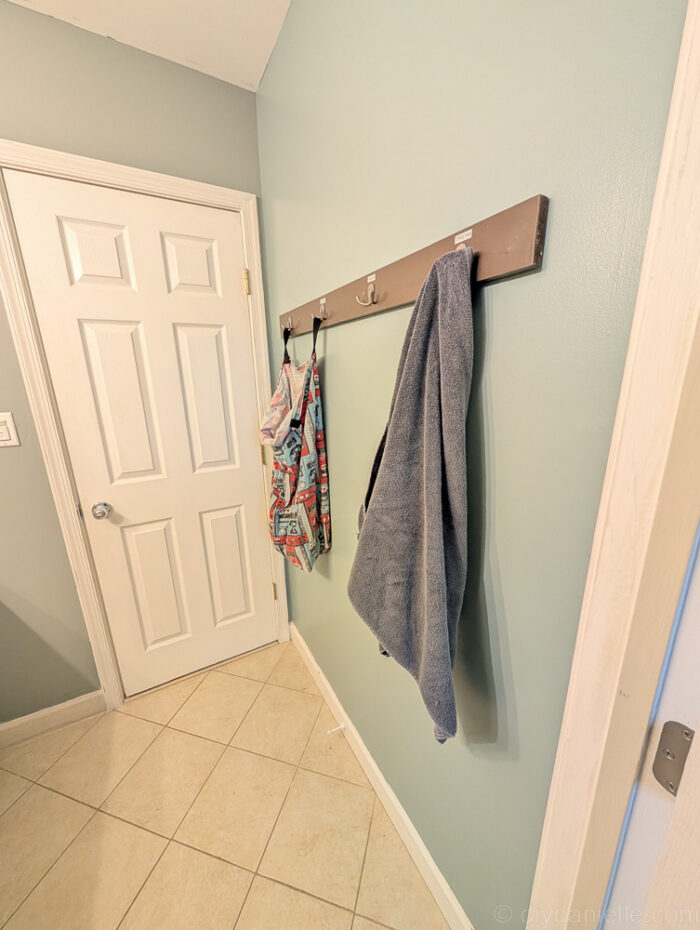 Hooks on the wall to hang towels and a laundry bag.