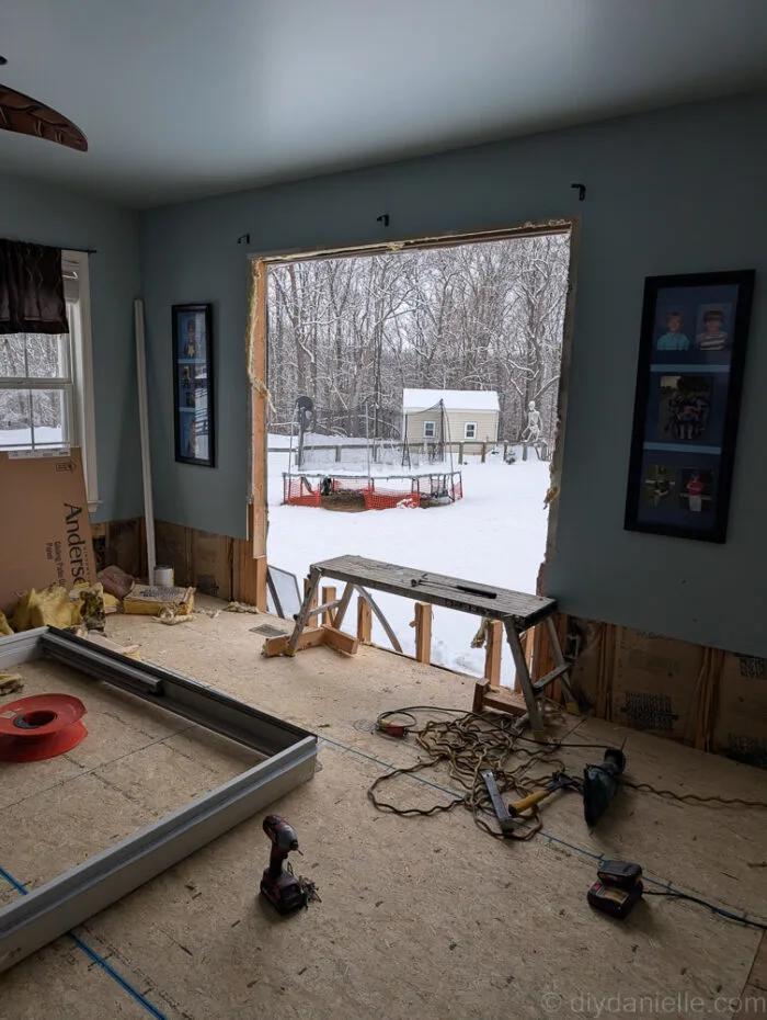 The windows were removed and the contractors cut out the full area for the sliding glass door. You can see the frame for the door on the floor.