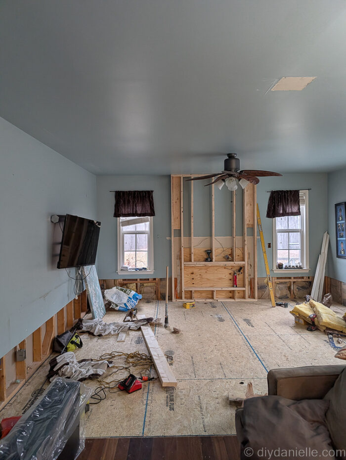 They framed out the area for the fireplace using 2x4s. This bumps out the wall a little bit in that area which looks really nice. They added plywood to cover the fireplace opening.