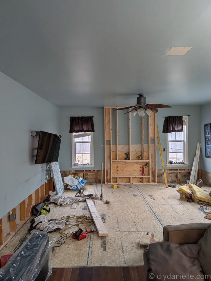 They framed out the area for the fireplace using 2x4s. This bumps out the wall a little bit in that area which looks really nice. They added plywood to cover the fireplace opening.