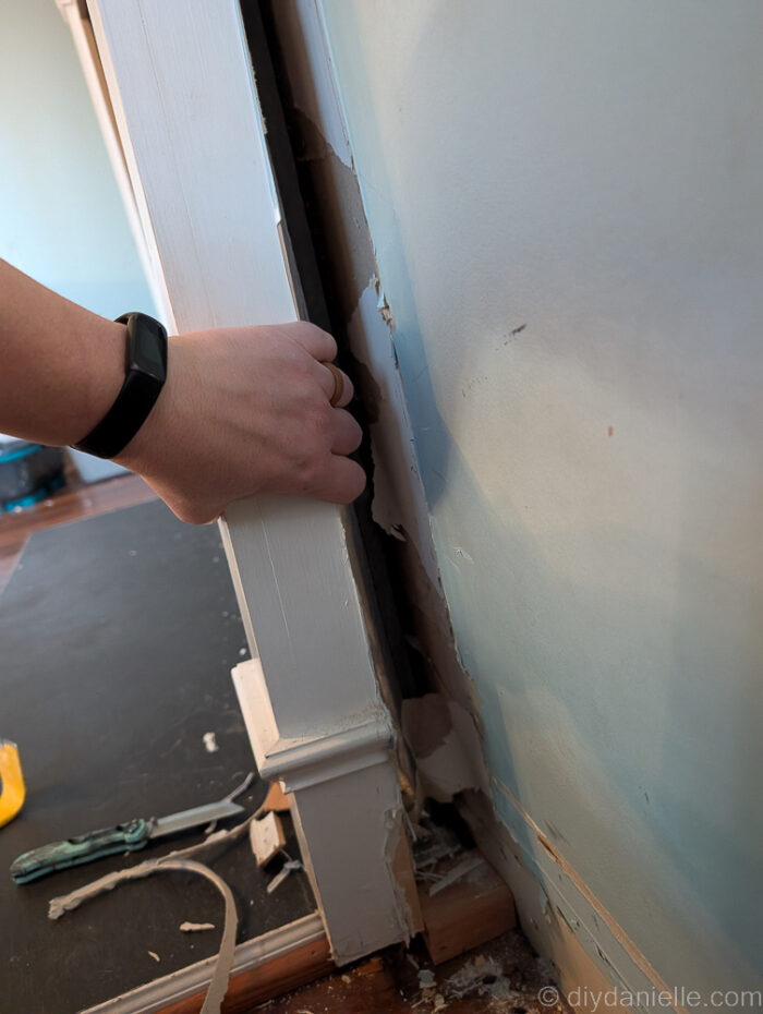 Pulling away the original mantle for the wood burning fireplace.