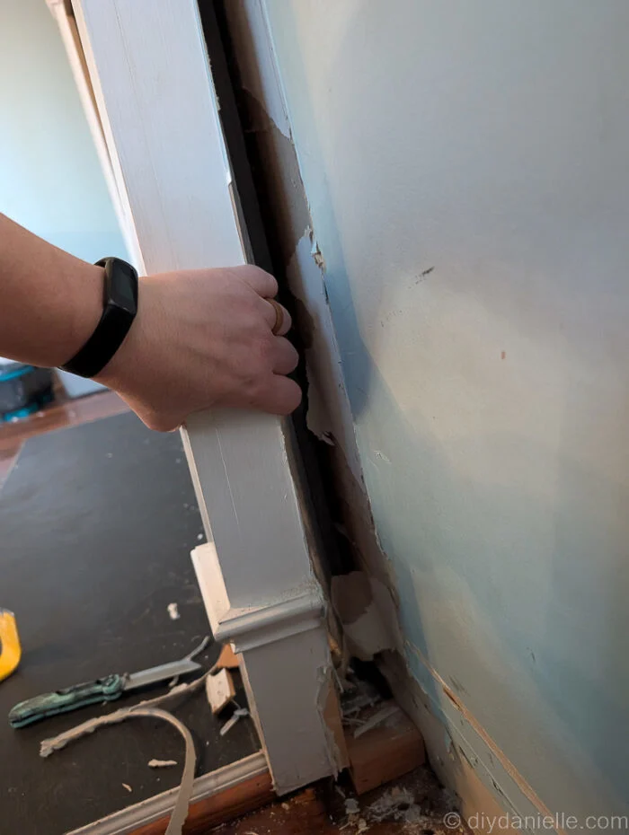 Pulling away the original mantle for the wood burning fireplace.