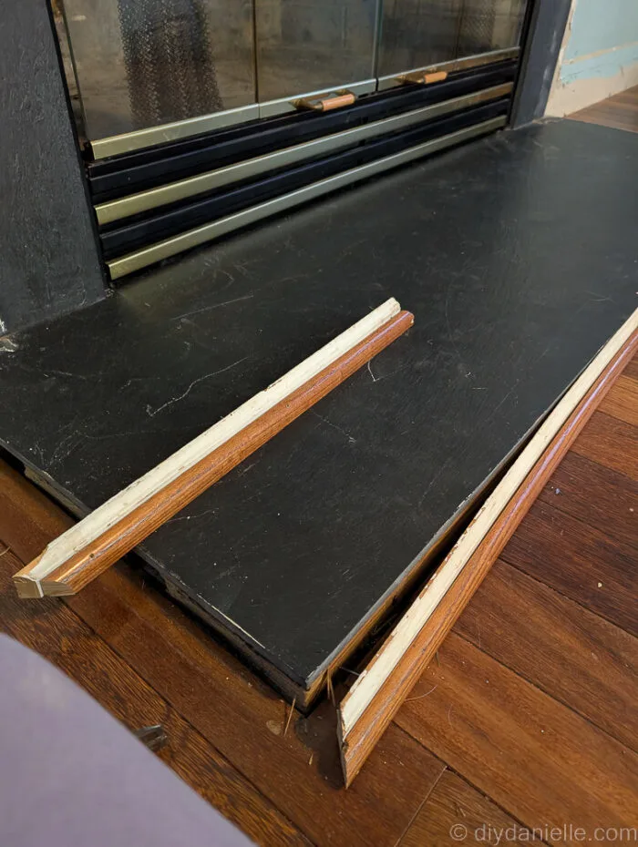 Removing the trim around the slate around the fireplace.