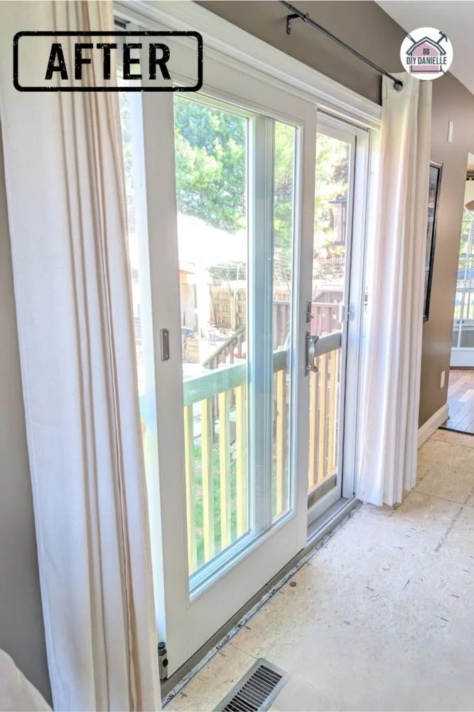 After Photo: We replaced two large windows in a living room that were side by side with a sliding glass door. The room is much more bright and airy now!
