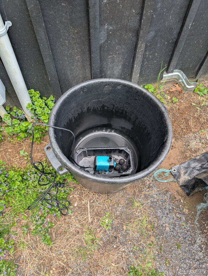 Used black muck bucket with the POPOSOAP Pond Filter with Pump Fountain Kit, 660GPH placed in the bottom. No water has been added yet and the kit isn't assembled yet.