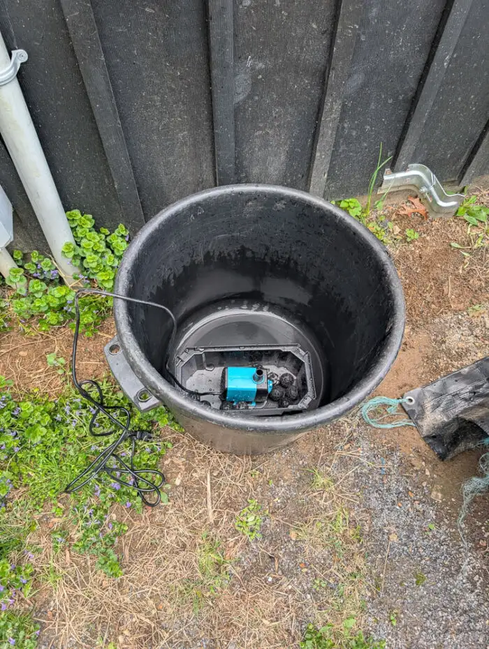Used black muck bucket with the POPOSOAP Pond Filter with Pump Fountain Kit, 660GPH placed in the bottom. No water has been added yet and the kit isn't assembled yet.