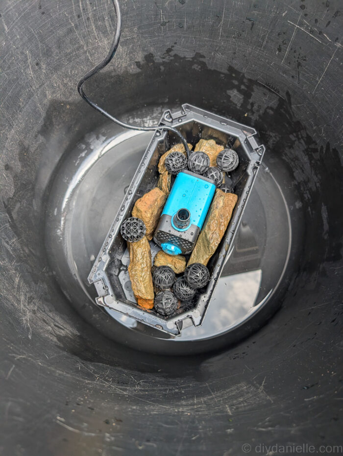 Used black muck bucket with the POPOSOAP Pond Filter with Pump Fountain Kit, 660GPH placed in the bottom. No water has been added yet. I have begun assembling the kit, adding rocks to the bottom of the box to help weigh it down in the water.