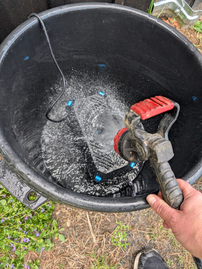 Used black muck bucket with the POPOSOAP Pond Filter with Pump Fountain Kit, 660GPH placed in the bottom. Water being added.