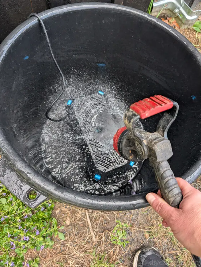 Used black muck bucket with the POPOSOAP Pond Filter with Pump Fountain Kit, 660GPH placed in the bottom. Water being added.