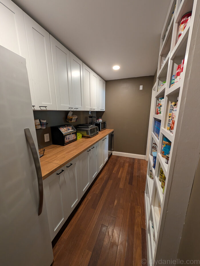 Opposite-angle view of the shelves, showcasing the full setup with trim and shelves installed.