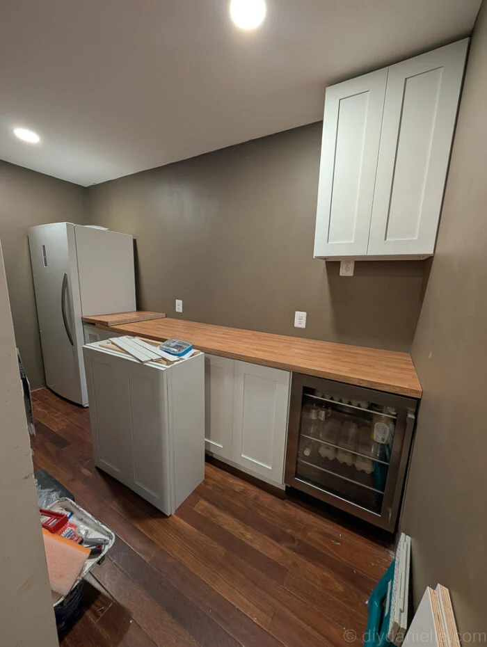 IKEA wood countertop with a slight extension using leftover piece from kids' bathroom renovation