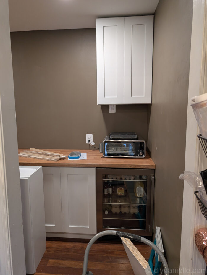 Newly installed freezer and minifridge, with IKEA wood countertop for clean, modern look and added functionality