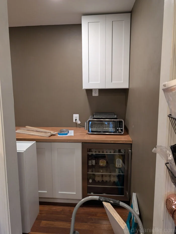 Newly installed freezer and minifridge, with IKEA wood countertop for clean, modern look and added functionality