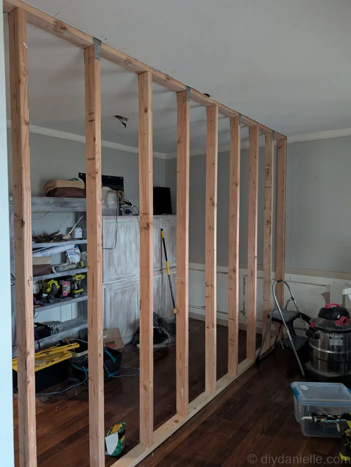 Wall fully framed with all 2x4s. Ready for the electrician and then the drywall.