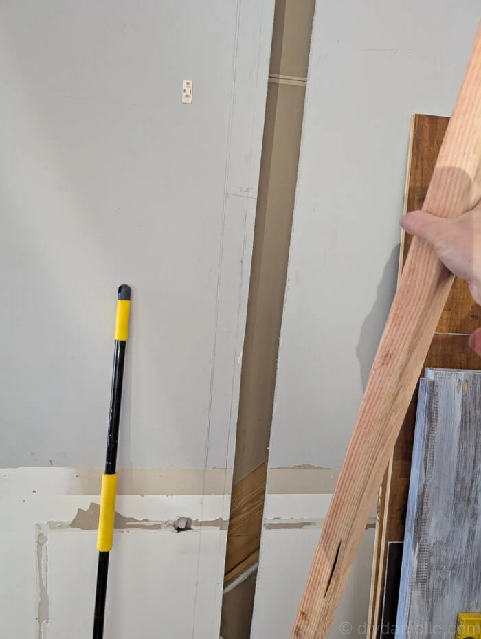 The side pieces for 2x4s need to be IN the wall and attached to the perpendicular wall's framing studs--- they cannot be attached through the drywall.