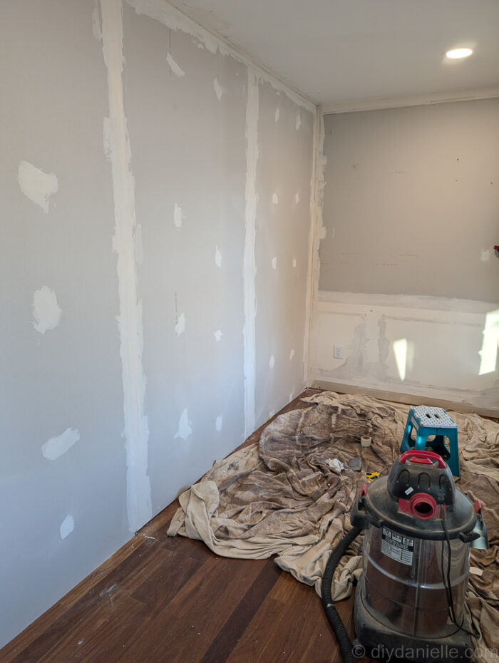Working on mudding the sheetrock for the new wall. Hallway side.