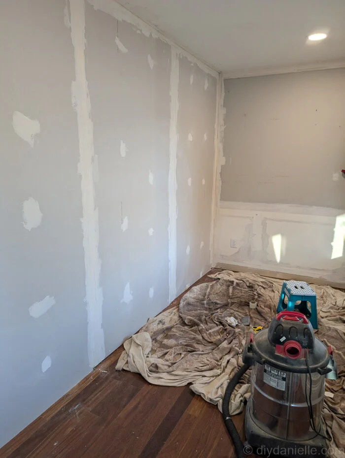 Working on mudding the sheetrock for the new wall. Hallway side.