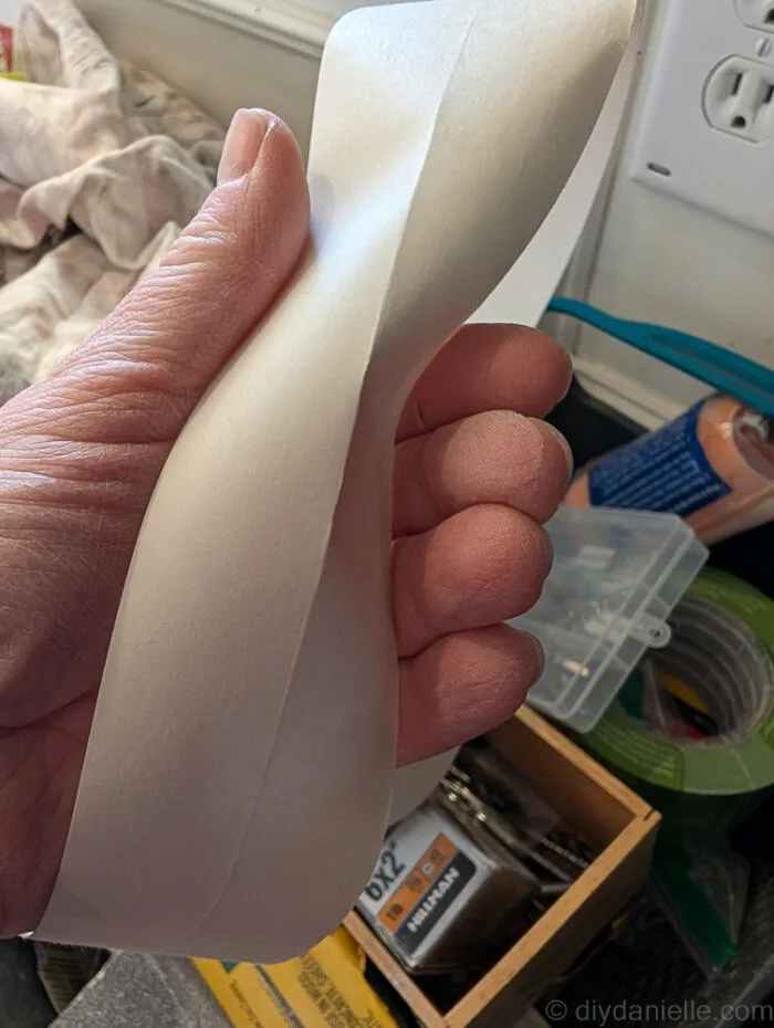 Photo of the drywall tape. There's a seam down the middle for easy folding for corners and for the ceiling/wall seam. The pokey side goes into the corner.