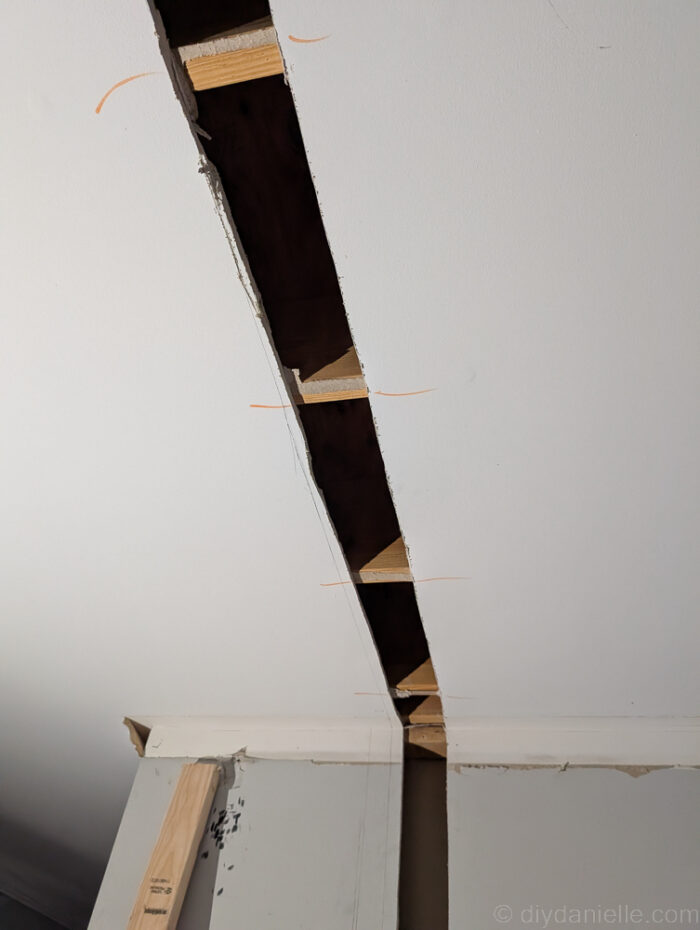 Old drywall cut away to prepare to place our new divider wall and framing.