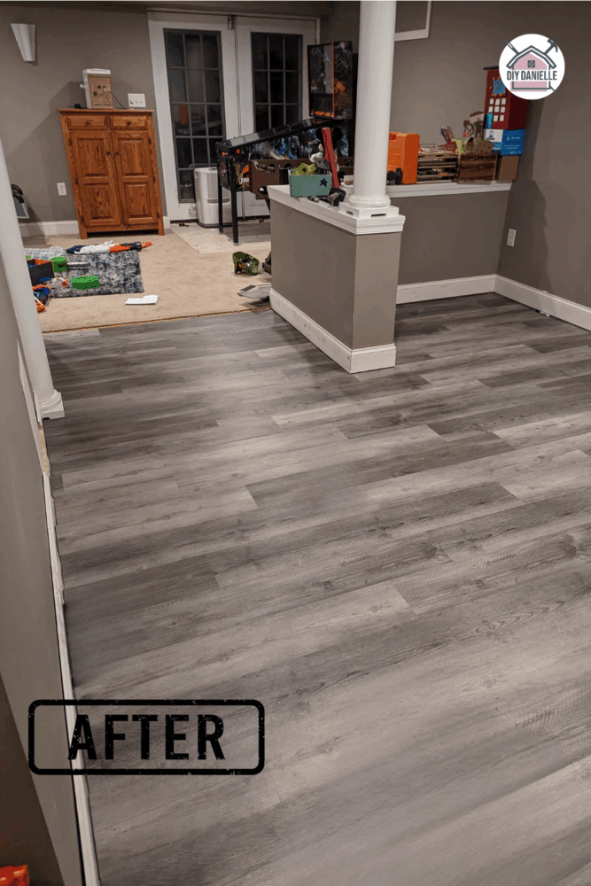 Newly installed laminate flooring in the basement during an emergency Christmas DIY project following plumbing repairs.
