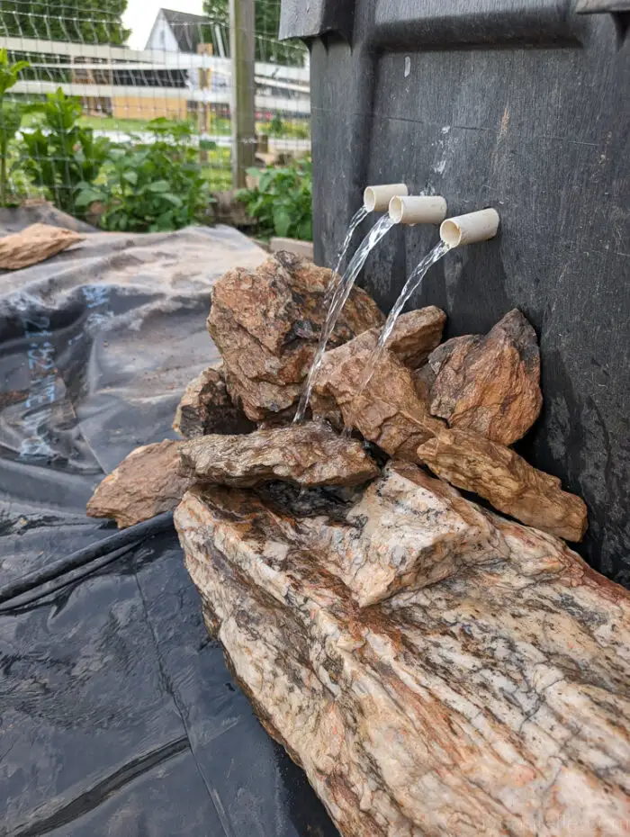 Stones added to the front of the bog filter, allowing water to waterfall down into the pond, with clearer water flowing out