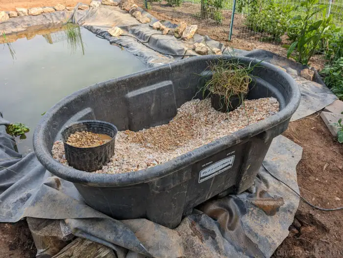 Final placement of the pond liner, showing how it was adjusted during the pond build process.
