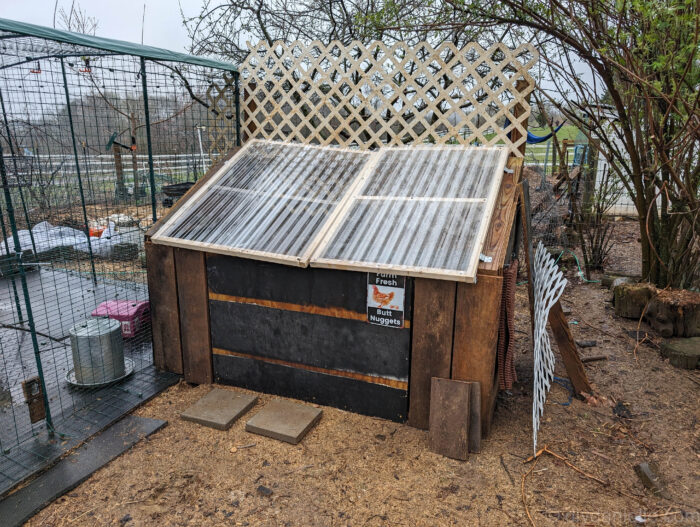 DIY feed shed with added center 2x4 support to fix sagging clear panel lids.