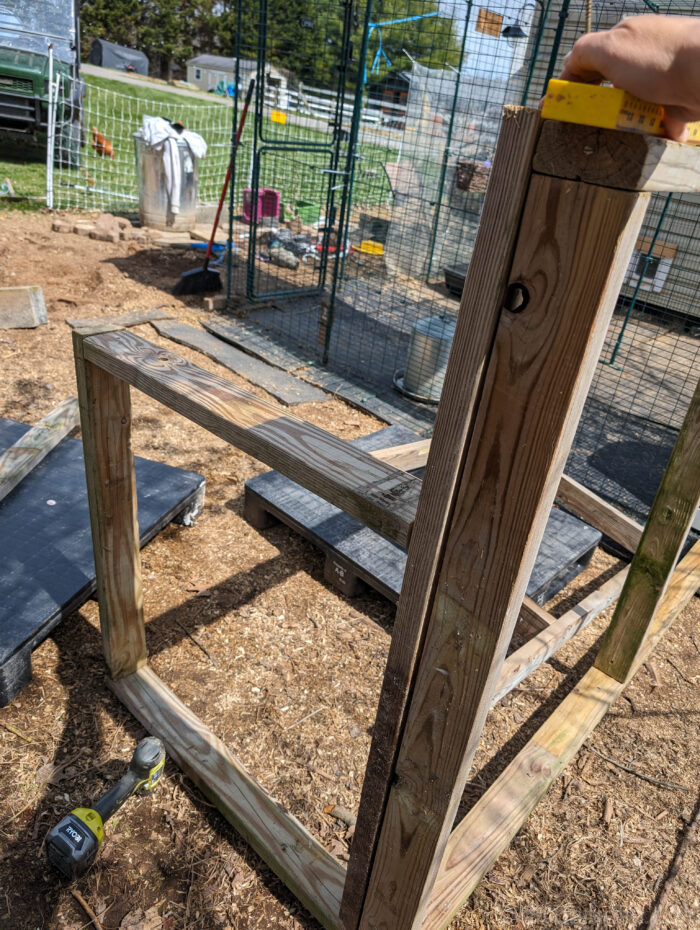 DIY feed shed frame built with 2x4 lumber for storing farm feed and supplies.