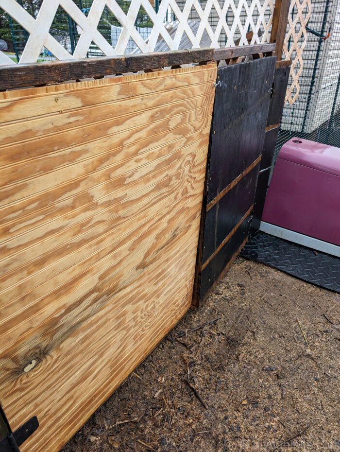 DIY chicken feed shed with side access area for moving metal feed bins easily.
