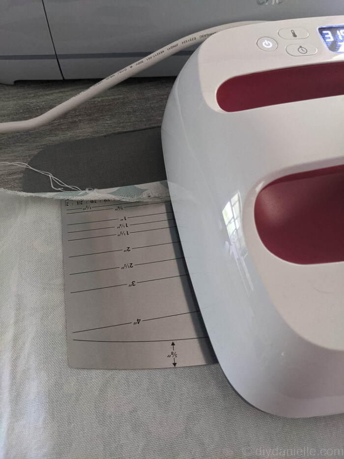 Close-up of fabric edge folded twice and pressed with an iron, ready to be sewn for a clean hem.