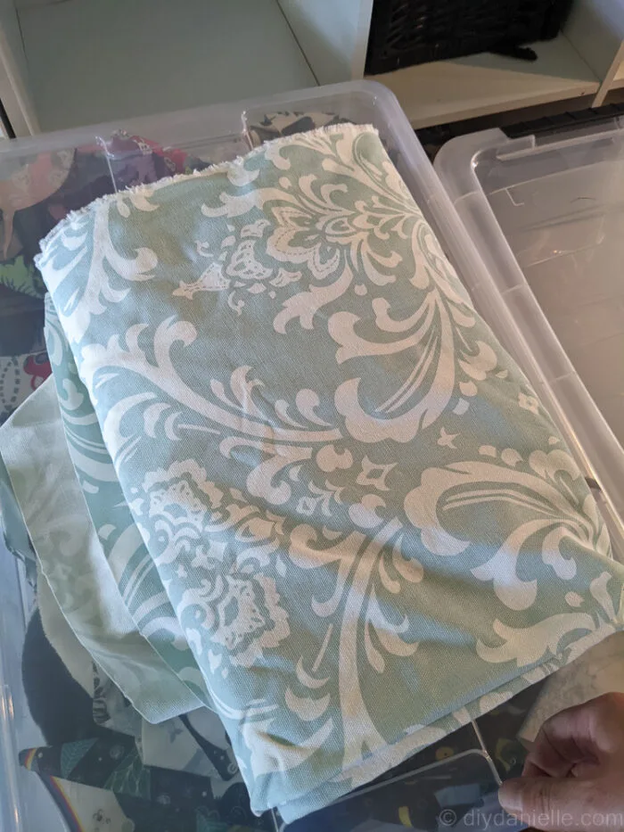 Close-up of durable, washable fabric used for a DIY dog crate cover, draped over a wire crate.