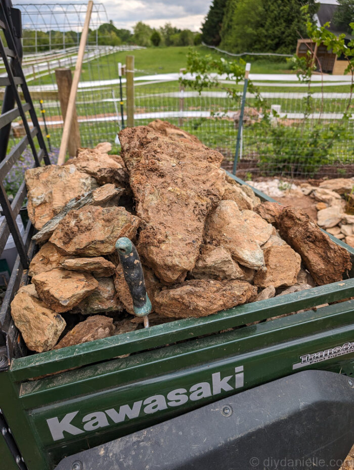 Placing foraged rocks around the pond edge to secure the liner and create a natural look.