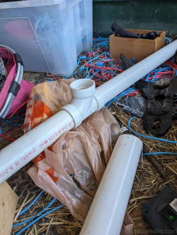 PVC pipe installed inside the bog filter trough with drilled holes for water flow and capped ends for even distribution
