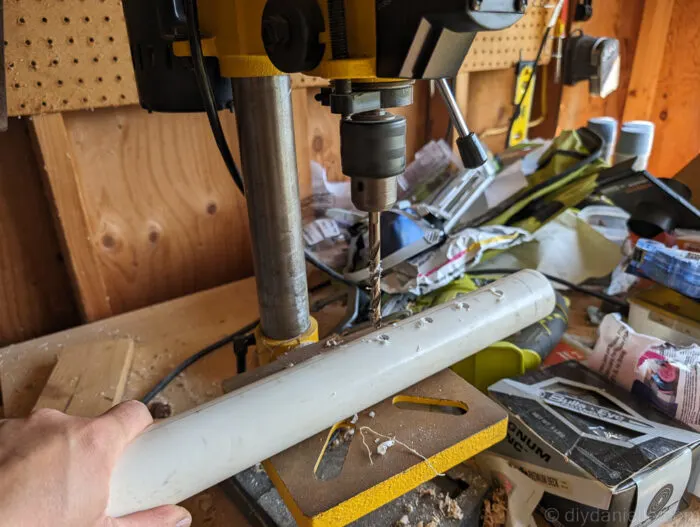 PVC pipe setup inside the bog filter trough, with drilled holes for even water flow and capped ends for controlled distribution.