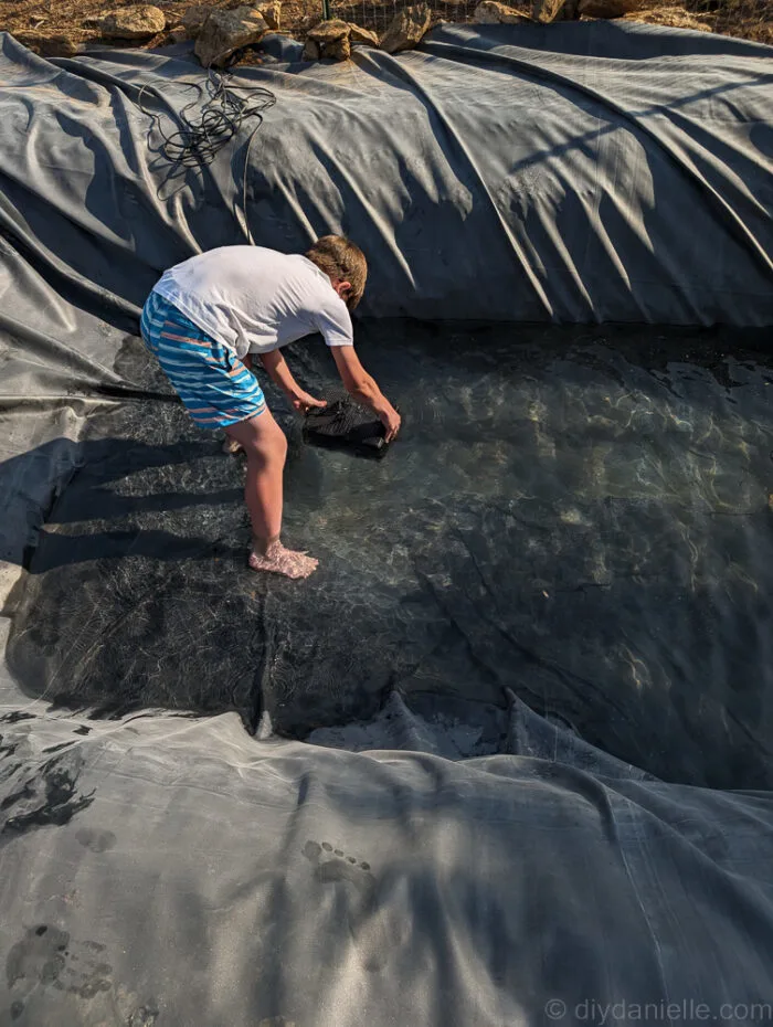Setting up pond aeration and running plumbing for the bog filter during installation.