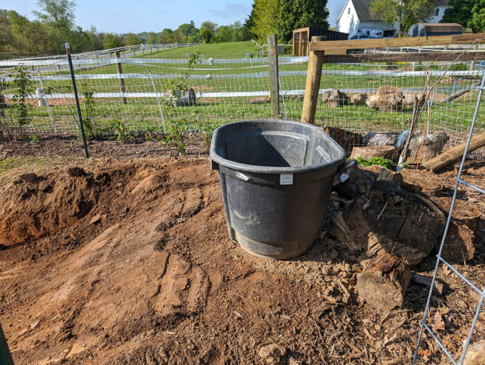 Installing a bog filter trough at the end of the pond to help with natural water filtration.
