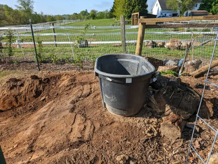 Installing a bog filter trough at the end of the pond to help with natural water filtration.