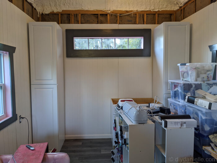 DIY pantry cabinet installation with door open toward wall