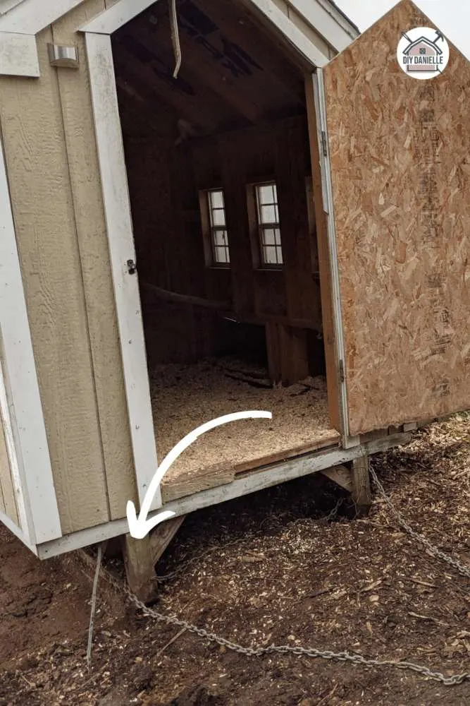 A shed built on wood skids for easy relocation and portable use in a backyard.