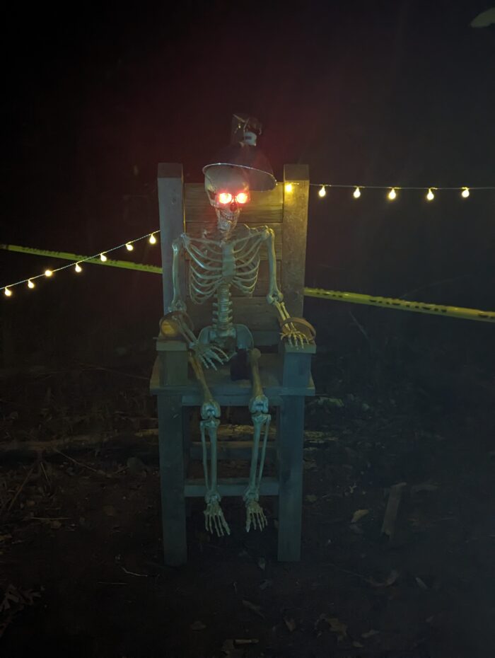 Close-up of skeletons and other DIY props for a haunted Halloween display.