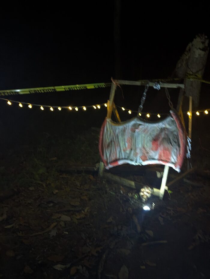 Halloween decorations including cages, skeletons, and lights for a spooky effect.