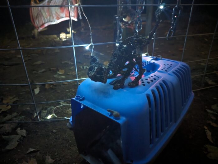 Xiew of a DIY Halloween setup with multiple props for a jail-themed scene.