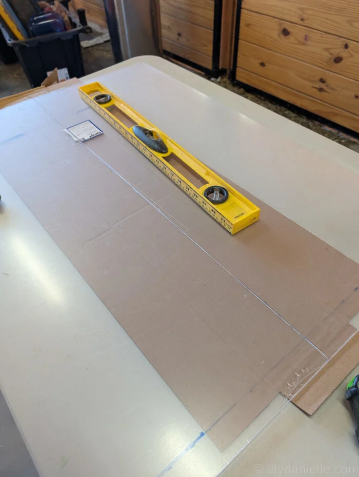 Clear acrylic panel installed as the front of a DIY digging area, allowing visibility inside the enclosure.