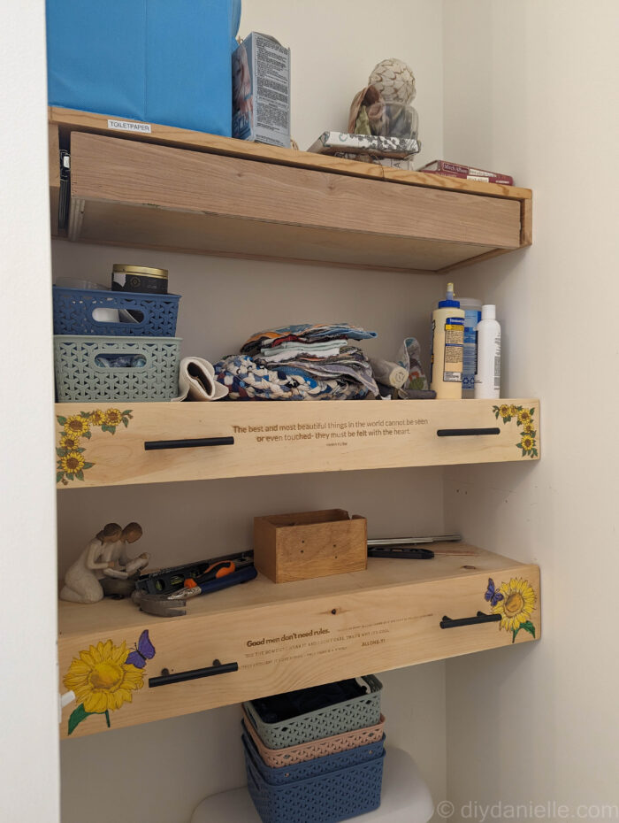 Two wooden drawer fronts fully installed next to a drawer box without its front panel, showing the progress of a DIY drawer project